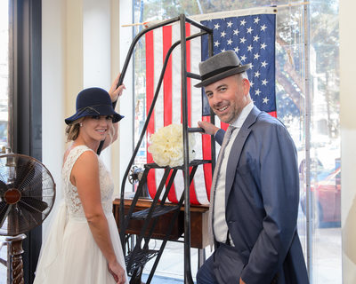 Bride and Groom having fun at the North Beach Hat Shop