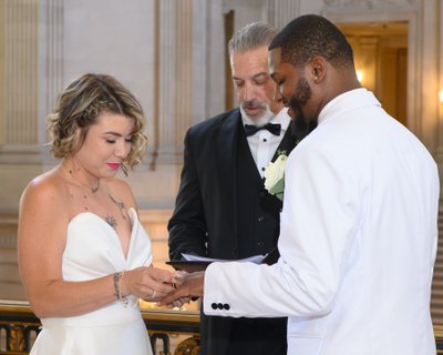 Eloping couple at SF City Hall exchanging rings