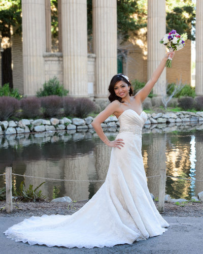fun bride at palace of fine arts with flower bouquet