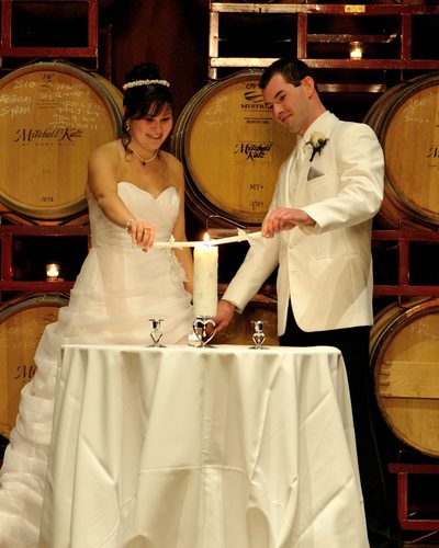 Bride and Groom Lighting Candles at the Palm Event Center