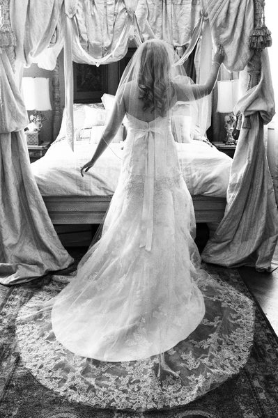 bride in grand room posing in her wedding dress