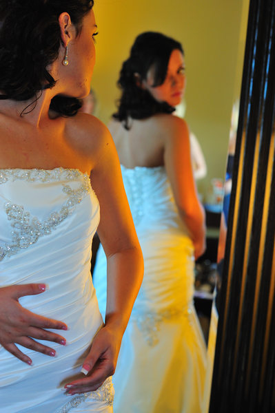 bride looking at back of dress