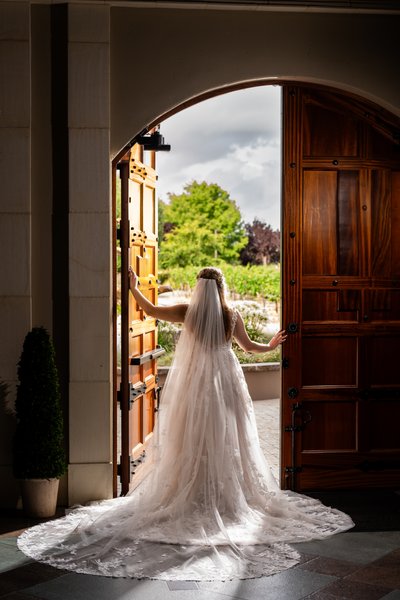 Casa Real Bride looking out through the cellar doors - wedding photography