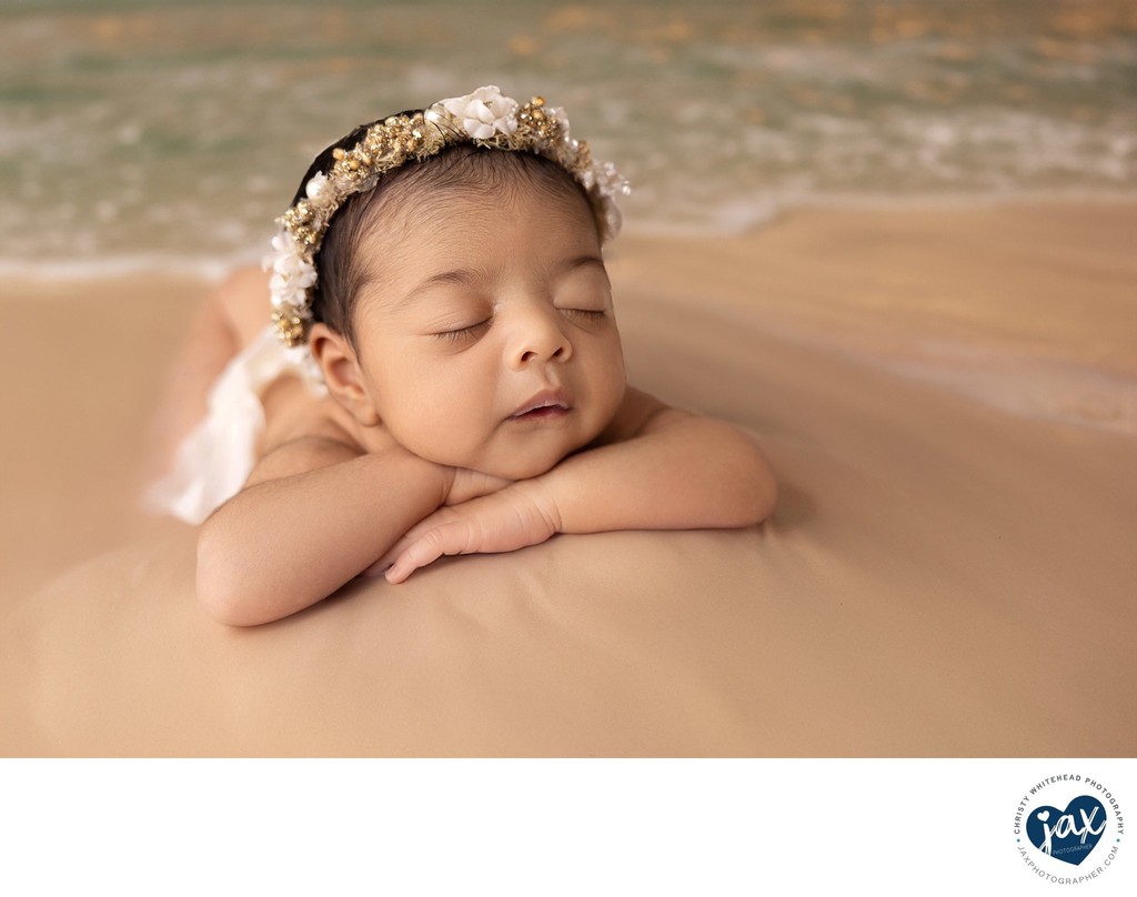 Newborn photograph in studio, edited to look like on beach