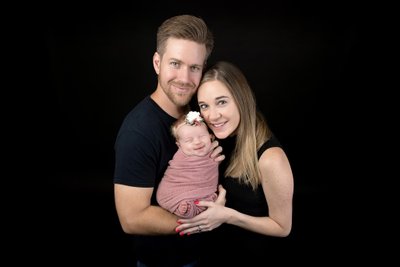 Smiling wrapped baby, family portrait session