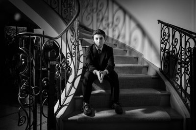 Senior portrait of a young man on a stair
