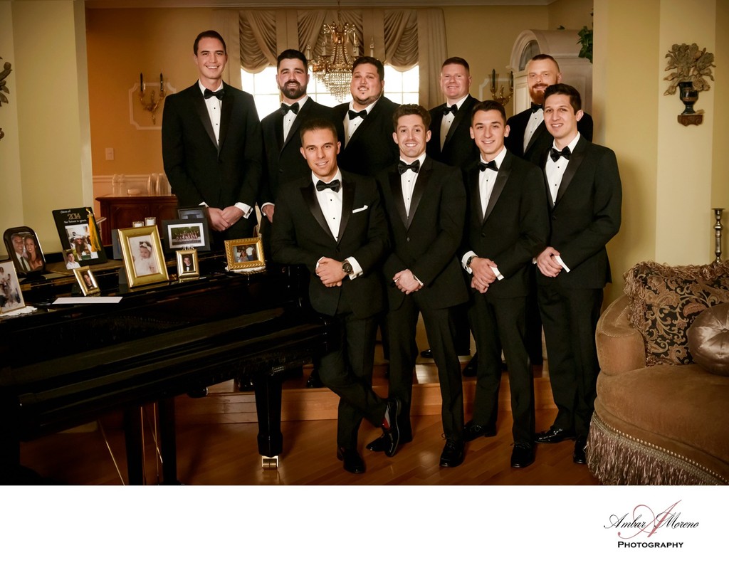 Groom and Groomsment posing in front of the grand piano