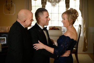 Father and Mother sharing a moment with their son before the wedding ceremony