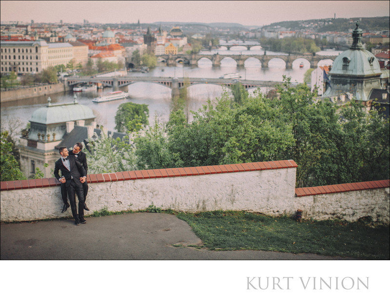 cuddling in their tuxedos overlooking Prague
