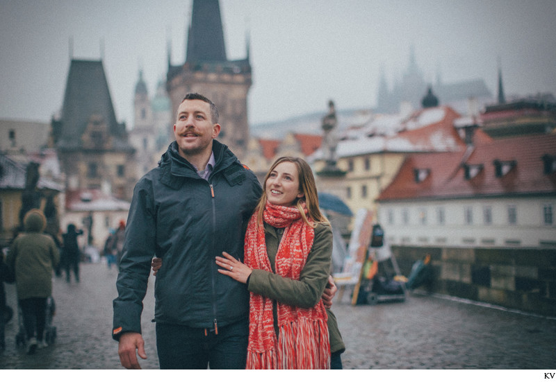 the newly engaged exploring the Charles Bridge 