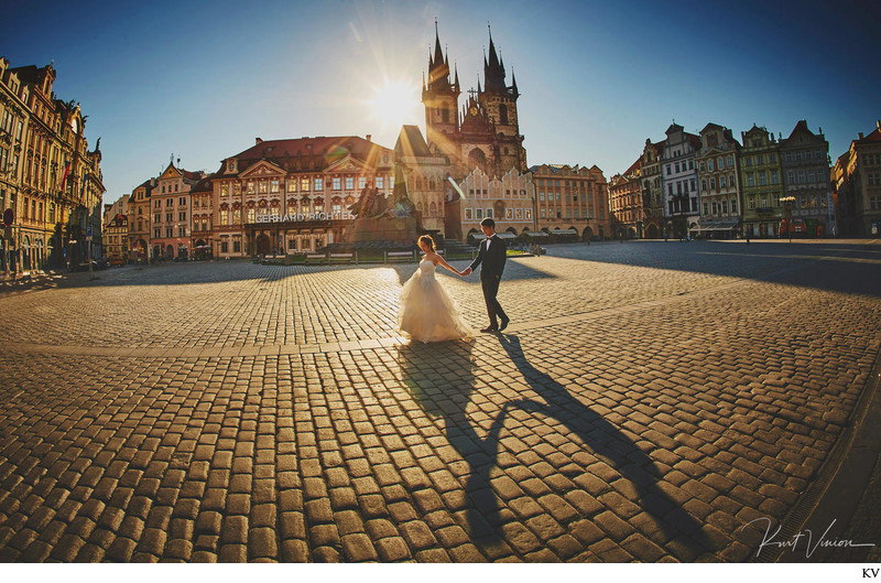 walking hand in hand at sunrise Old Town Square Prague