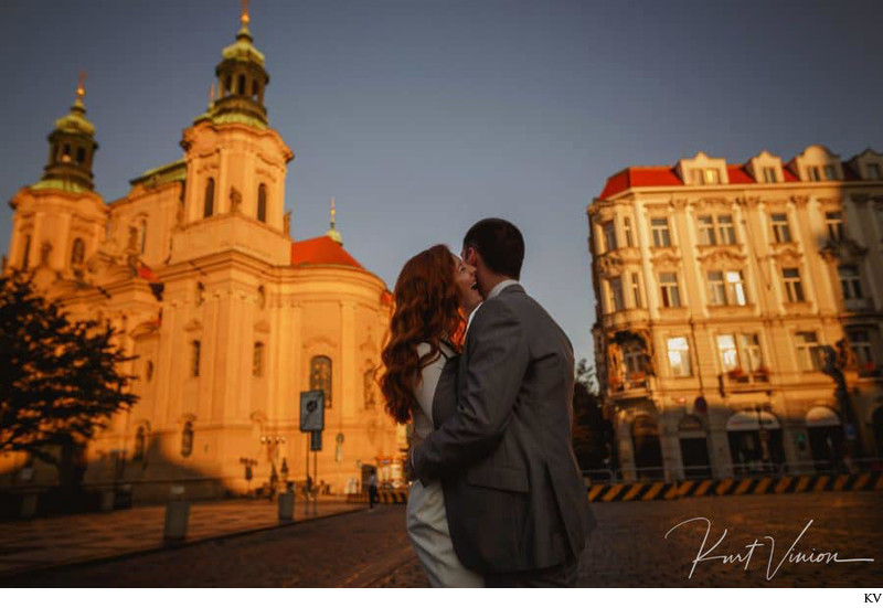 a laugh as the rising sun lights up Prague's Old Town