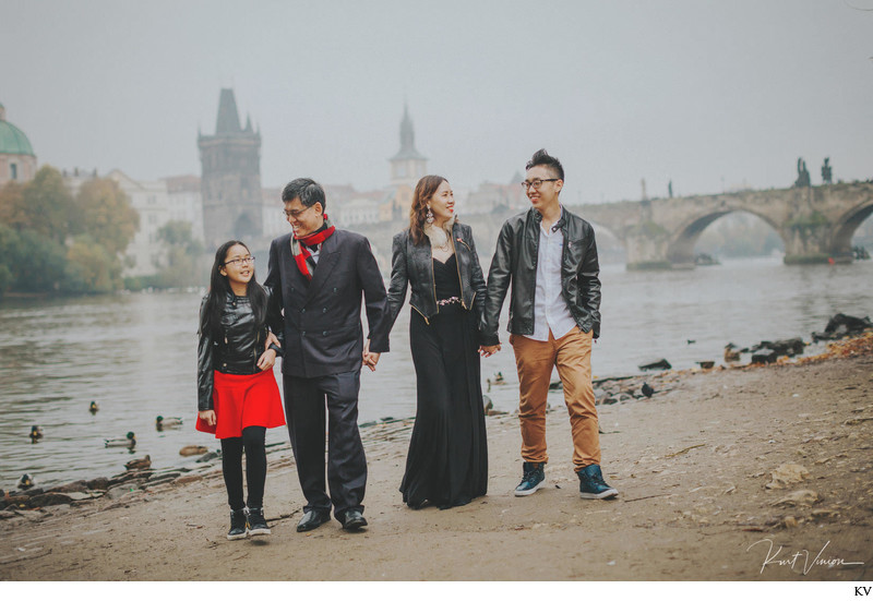 family walking hand in hand at the Charles Bridge