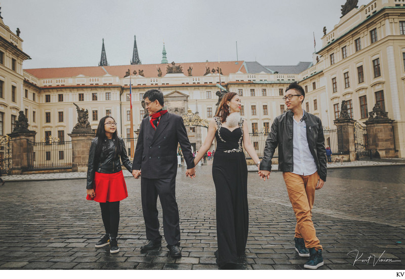 family walking hand in hand Prague Castle