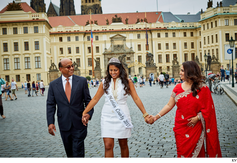 Proud parents walk hand in hand with their daughter