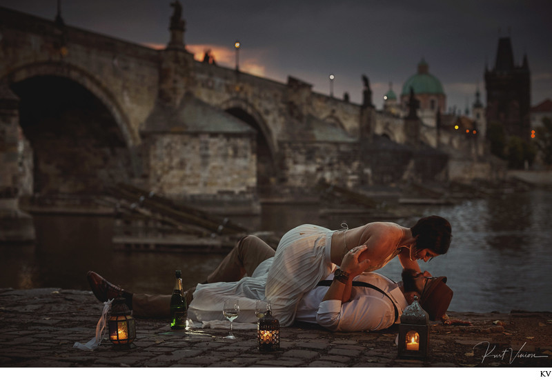 sexy Americans enjoying sunrise with champagne Charles Bridge