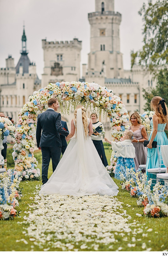 niece extends rose to the bride