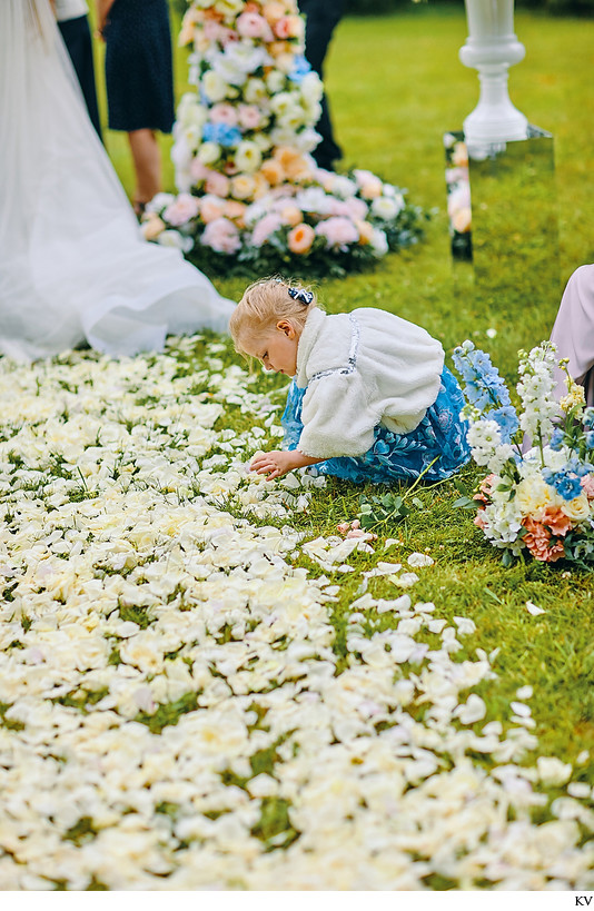 girl picking through the roses