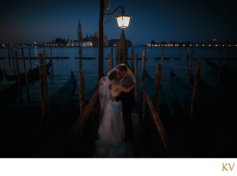 under the gas lamps near the gondolas in Venice