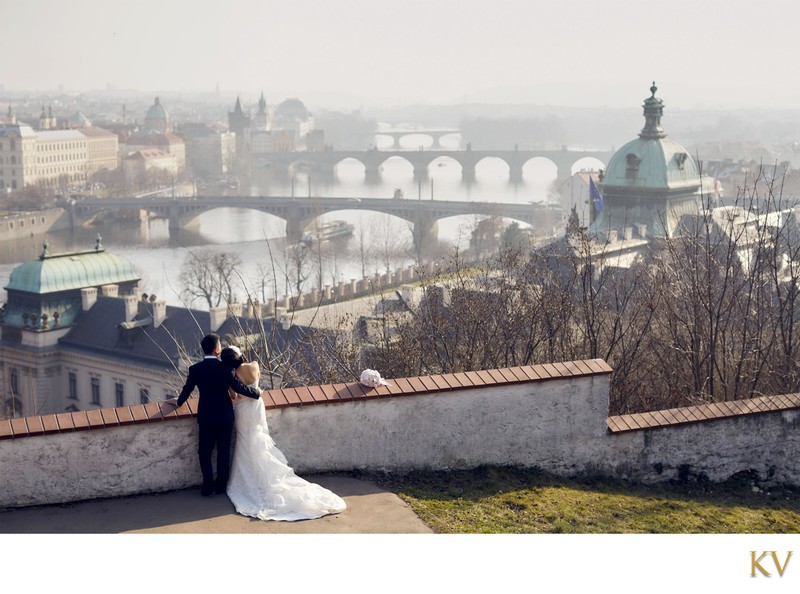 newlyweds enjoy stunning vista of misty Prague