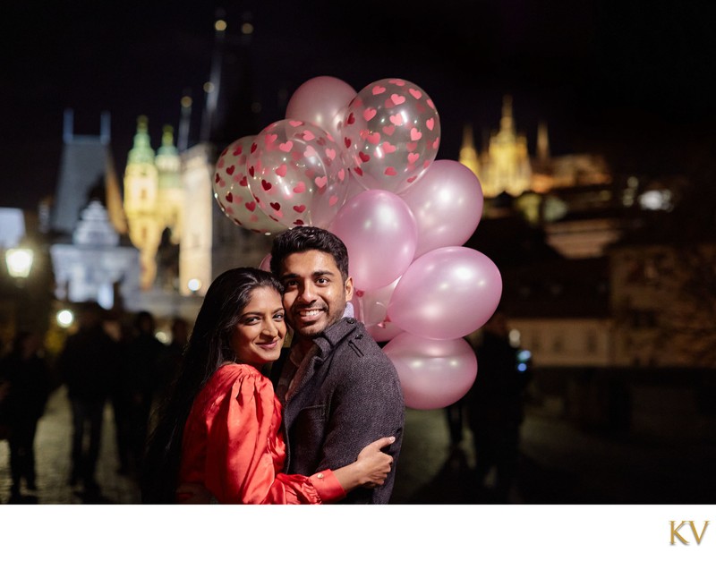 The happy couple and their balloons atop the Charles Bridge