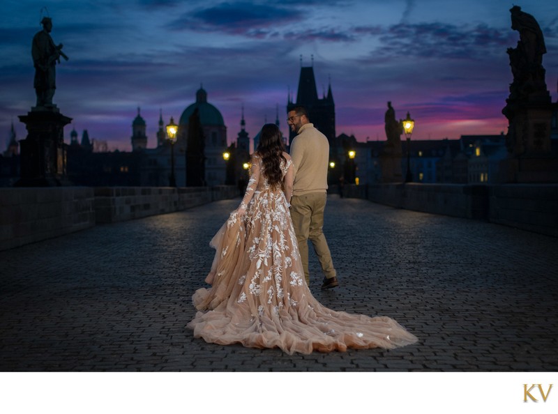 Walking hand-in-hand on the Charles Bridge at sunrise