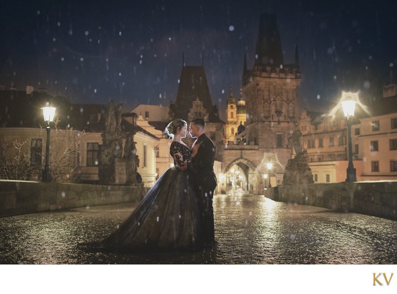 Gothic Bride & Groom atop Charles Bridge at night in the rain