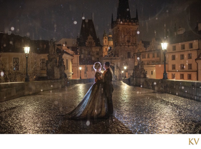 Gothic-inspired anniversary photo of couple atop Charles Bridge