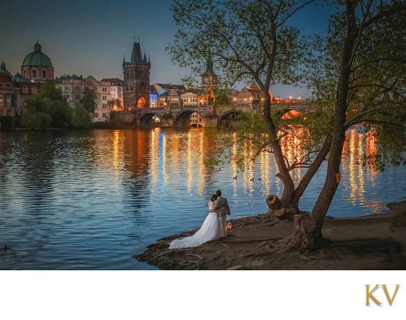 Newlyweds watch the sunrise over Charles Bridge