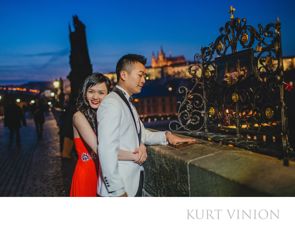 Hong Kong Newlyweds making a wish on the Charles Bridge 