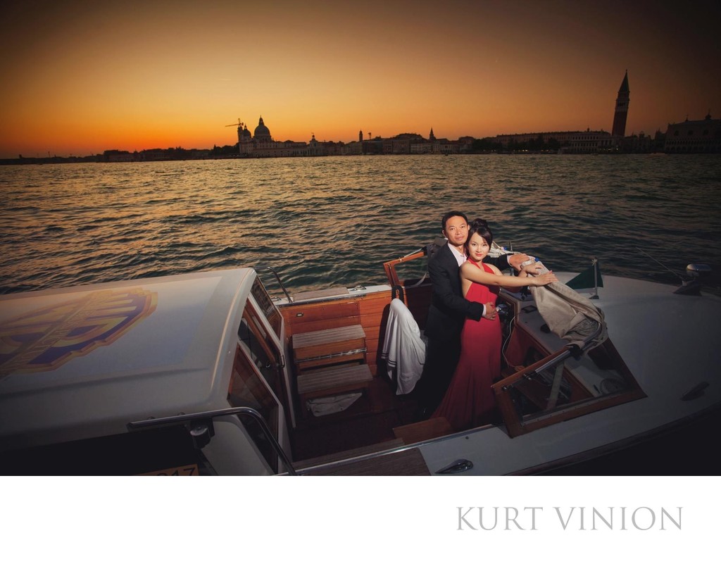 Thai couple in boat enjoying sunset over Venice