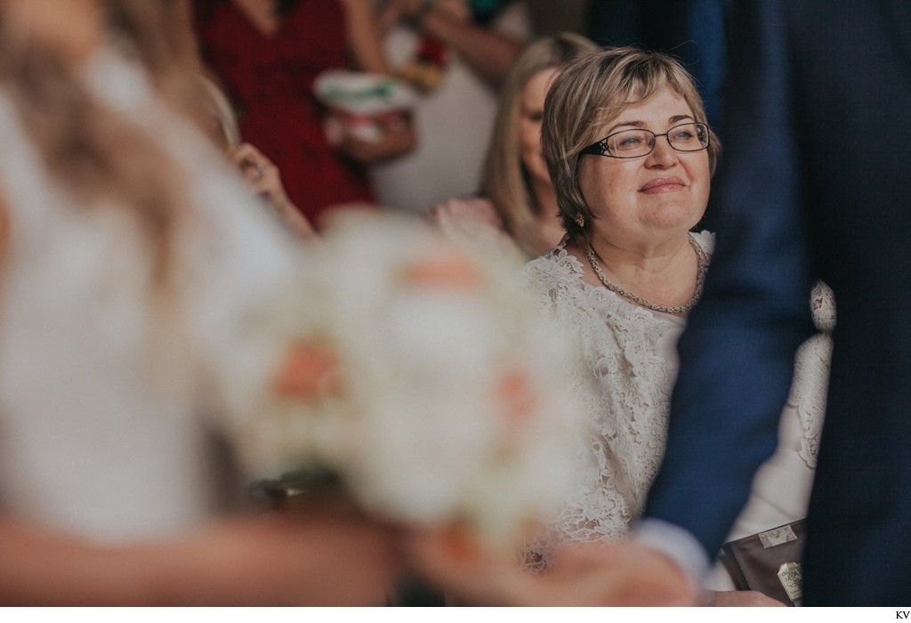 the proud mother of the groom watches her son