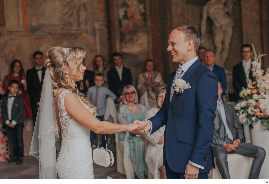 Holding his brides hand during ceremony