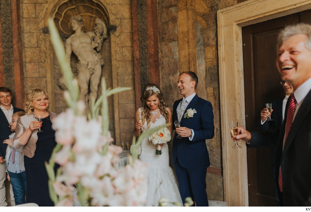 beaming newlyweds during champagne toasts