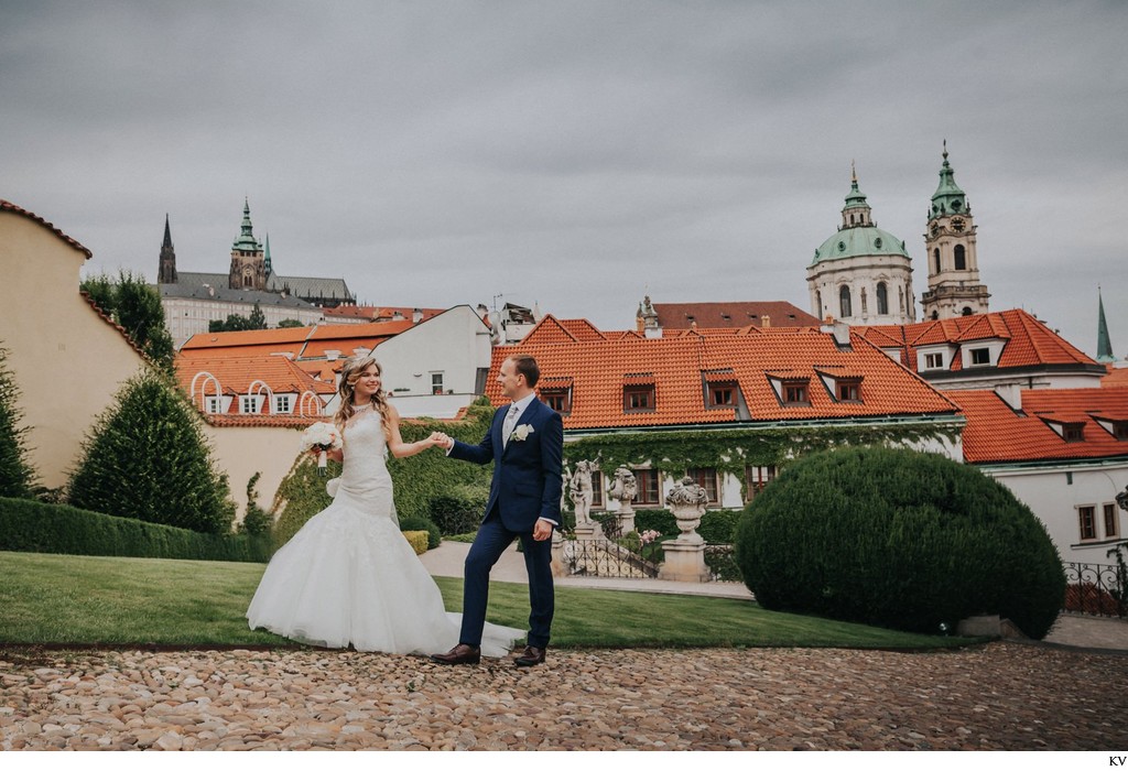 Bride & Groom walk with Prague Castle in background 
