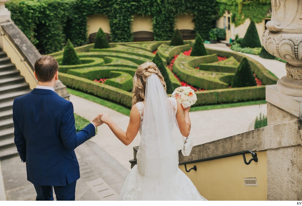 escorting his bride down the stairs 