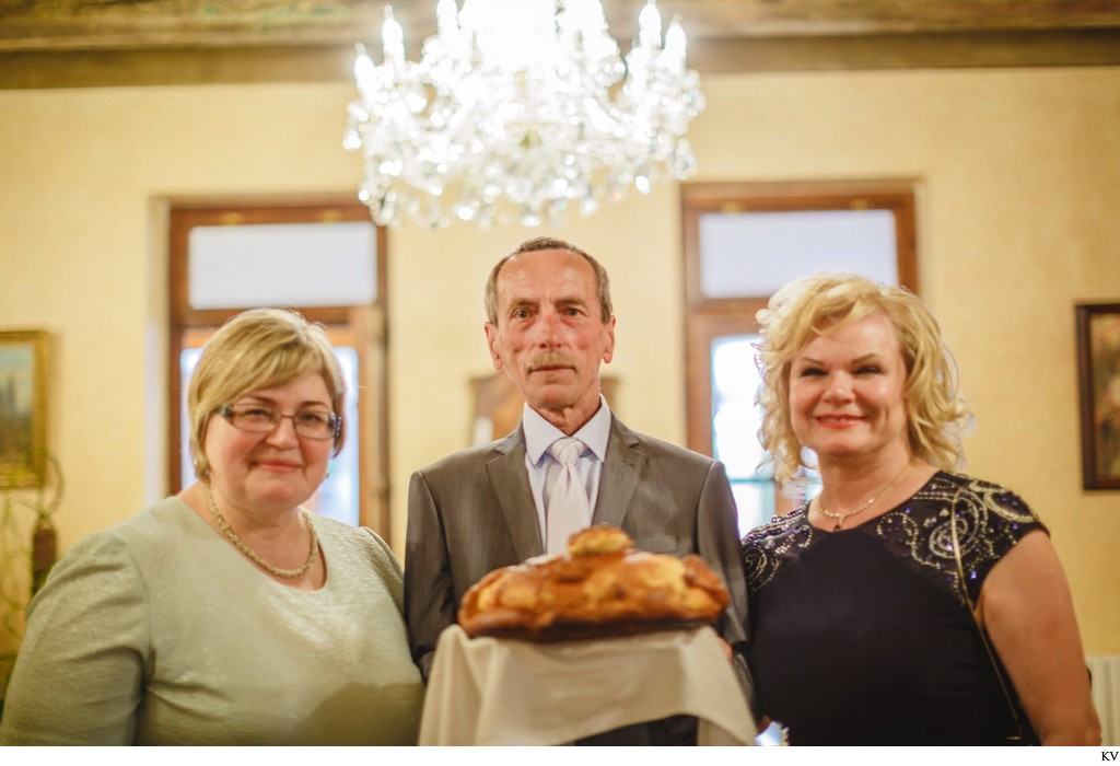 The parents wait with the traditional bread