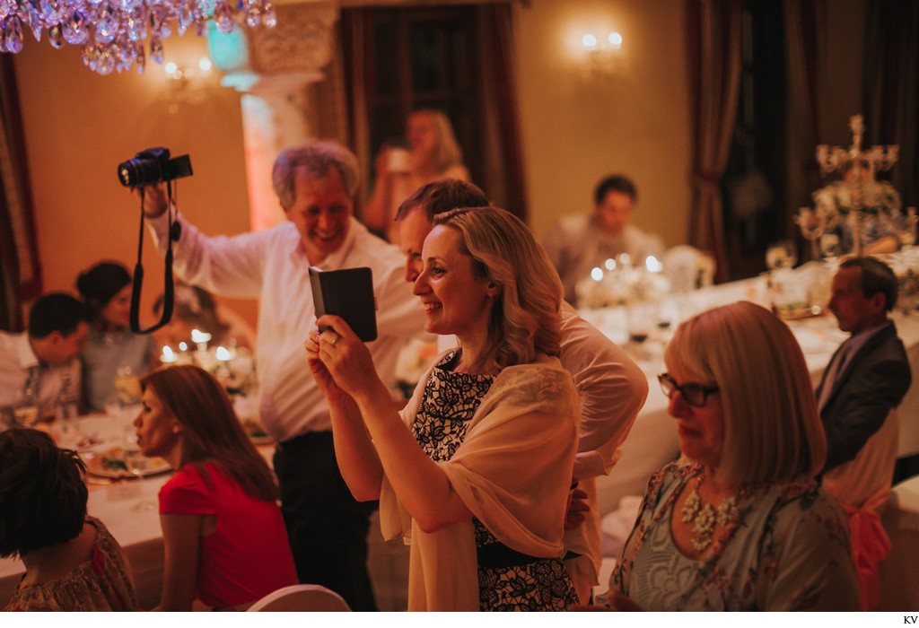 wedding guests take pictures during the party