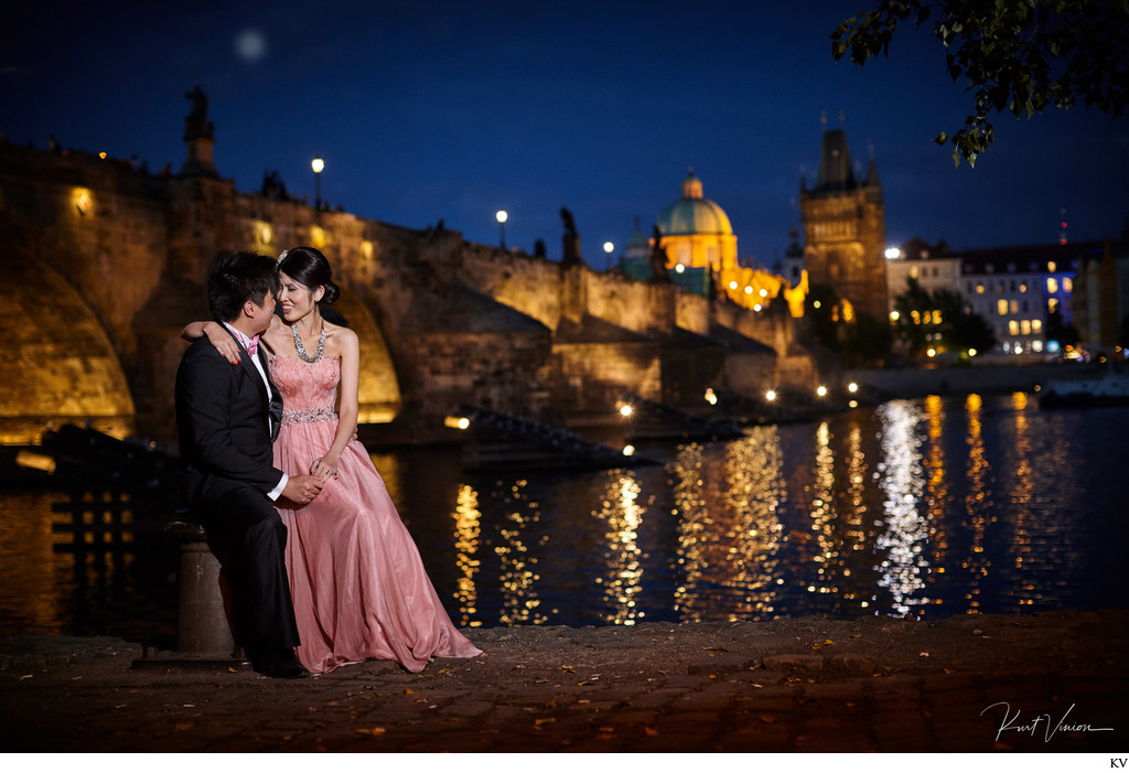 elegant lovers near Charles Bridge at night