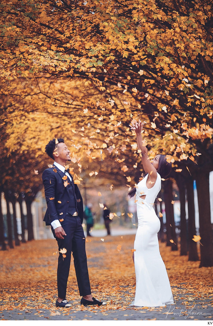 engaged stylish couple with leaves Prague