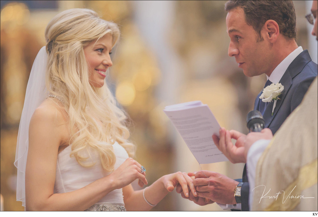 groom placing ring