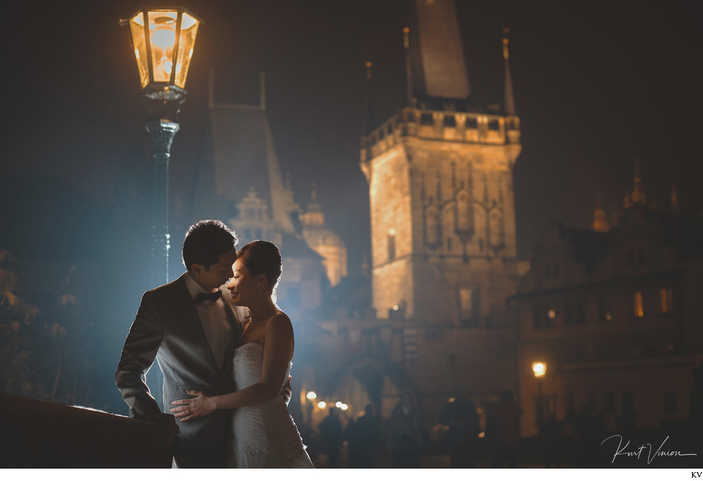 Charles Bridge lovers under gas lamp Prague pre wedding