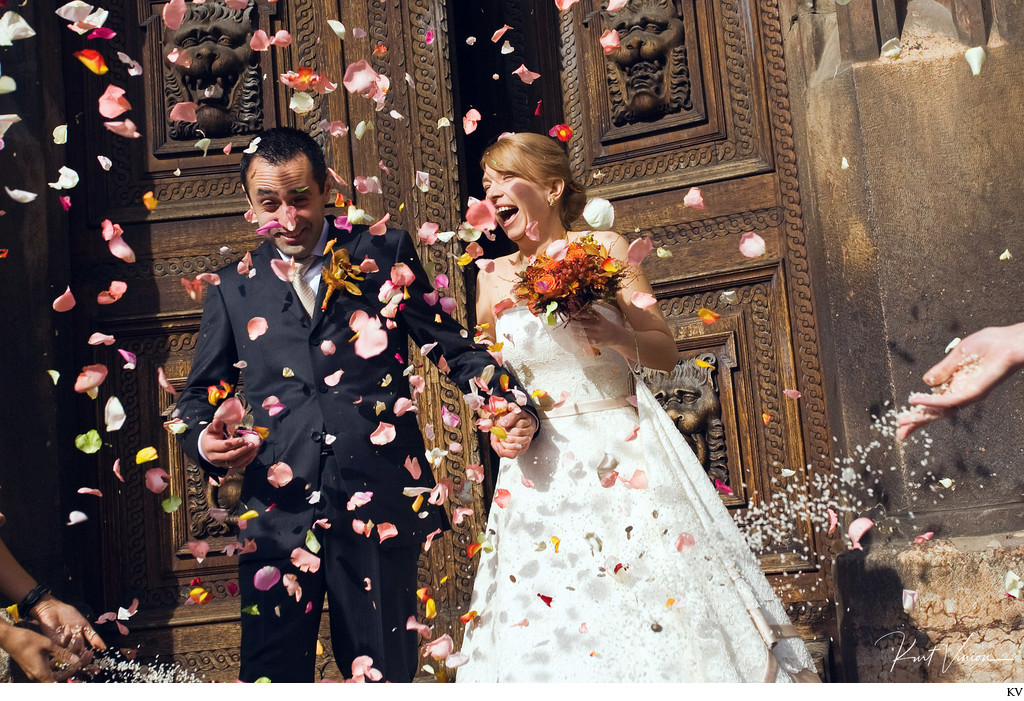 Prague wedding couple showered in rose petals & rice 