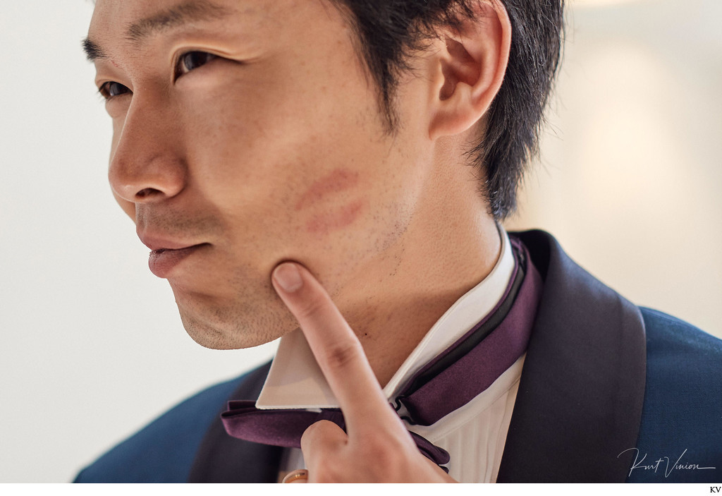 Groom shows brides kiss