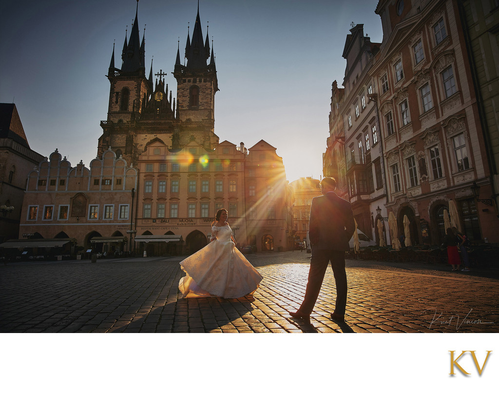 Newlyweds celebrating in Old Town Square at sunrise