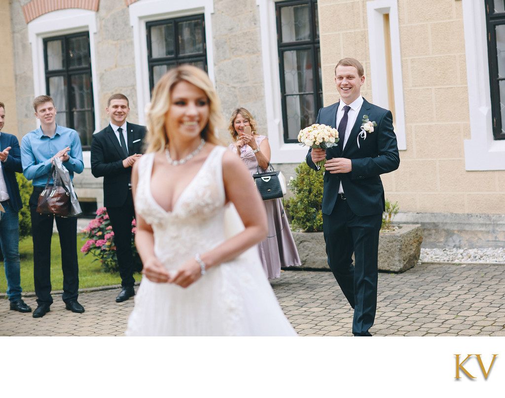 The groom walks up to his bride from behind