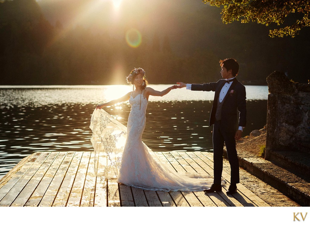 Holding his brides hand  Golden Light of Lake Bled