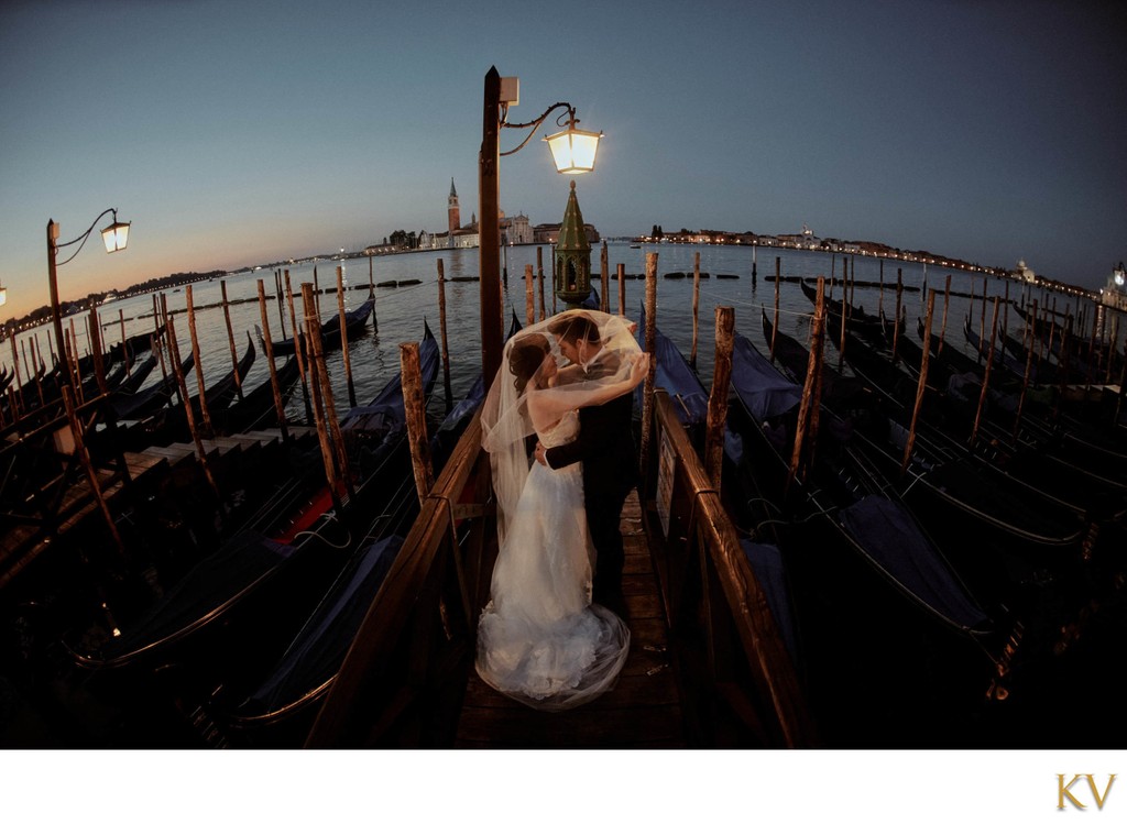 covering the groom with her veil