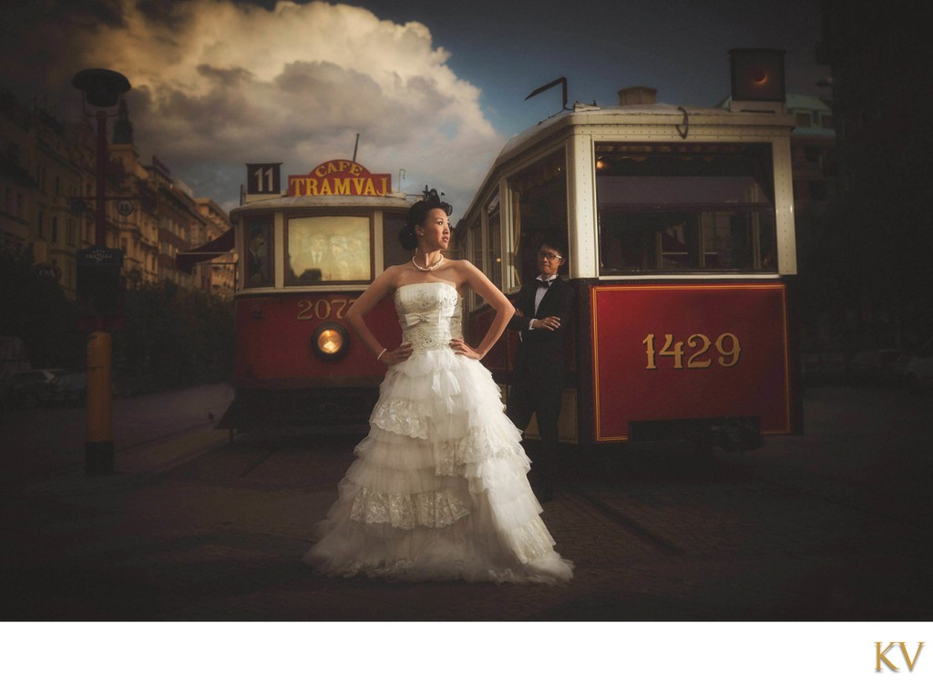 Stylish Newlyweds Posing Near Vintage Trams