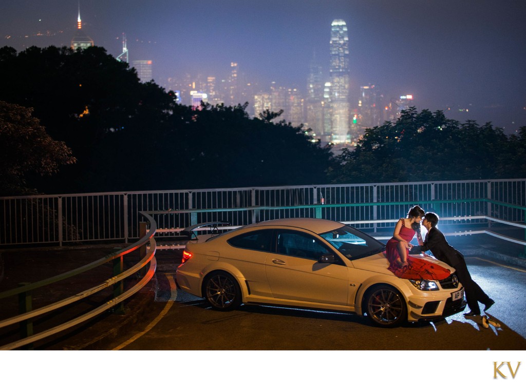 woman in red on Mercedes overlooking Hong Kong